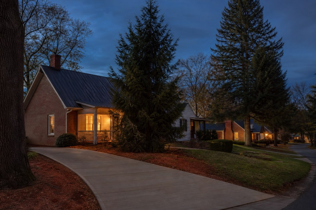 Freshly poured concrete driveway at a small historic mill house in McAdenville with mature trees along the street